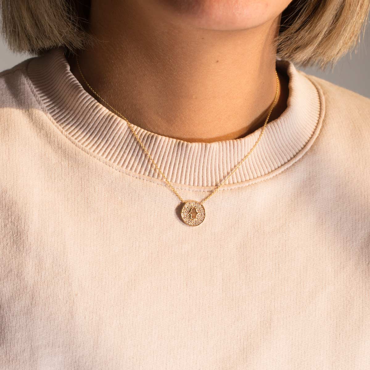 Hamsa white gold necklace in