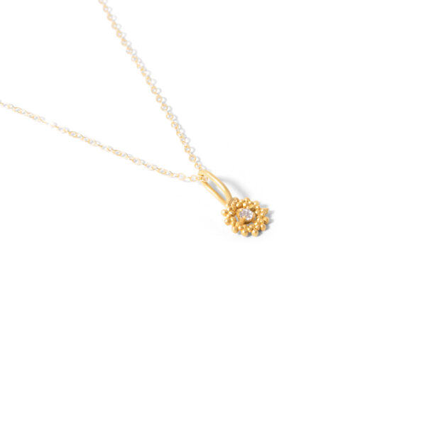 Gold necklace with single gem and ball g